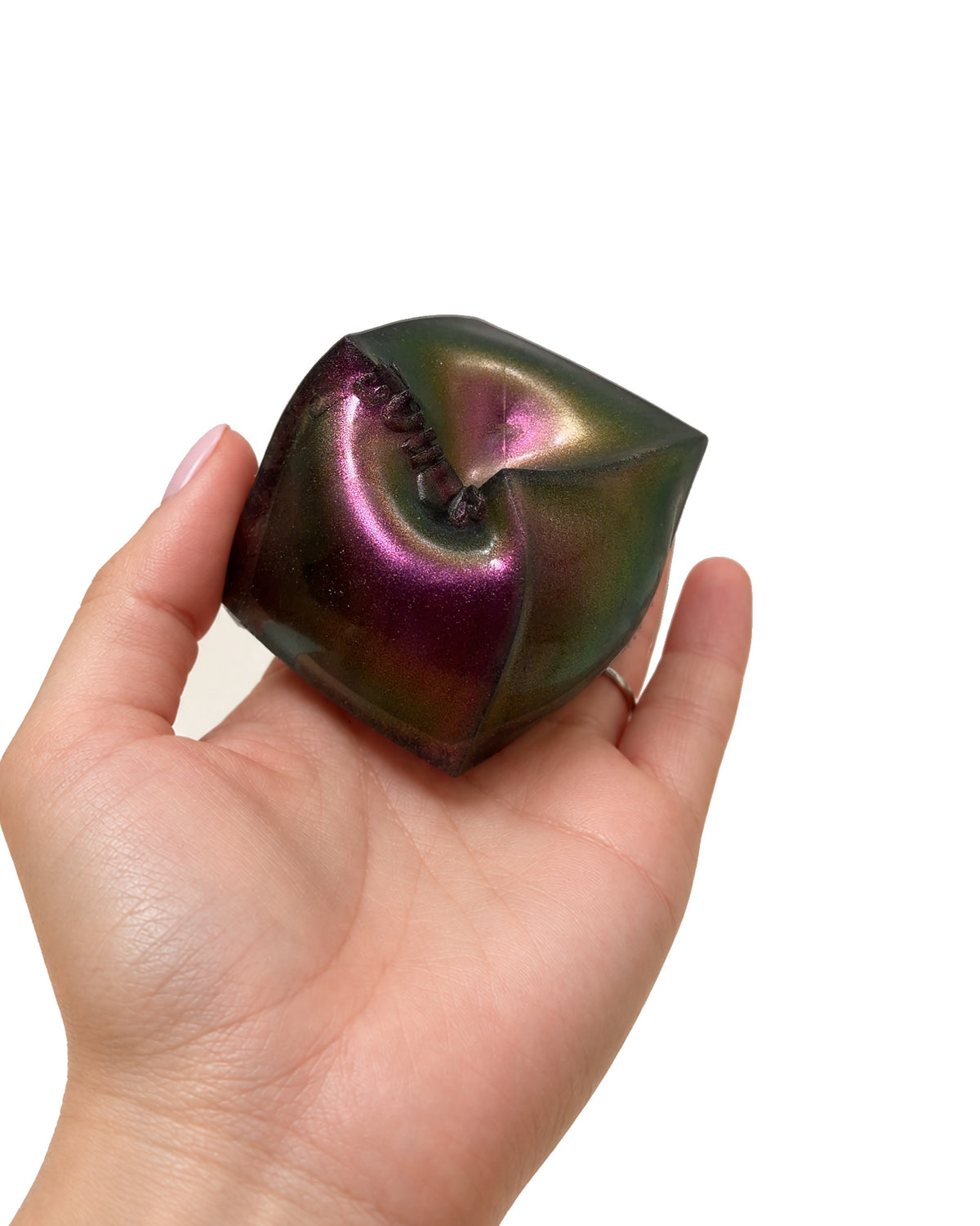 A colour-shifting PolySquish Discovery Series #2 shape resting in an open hand
