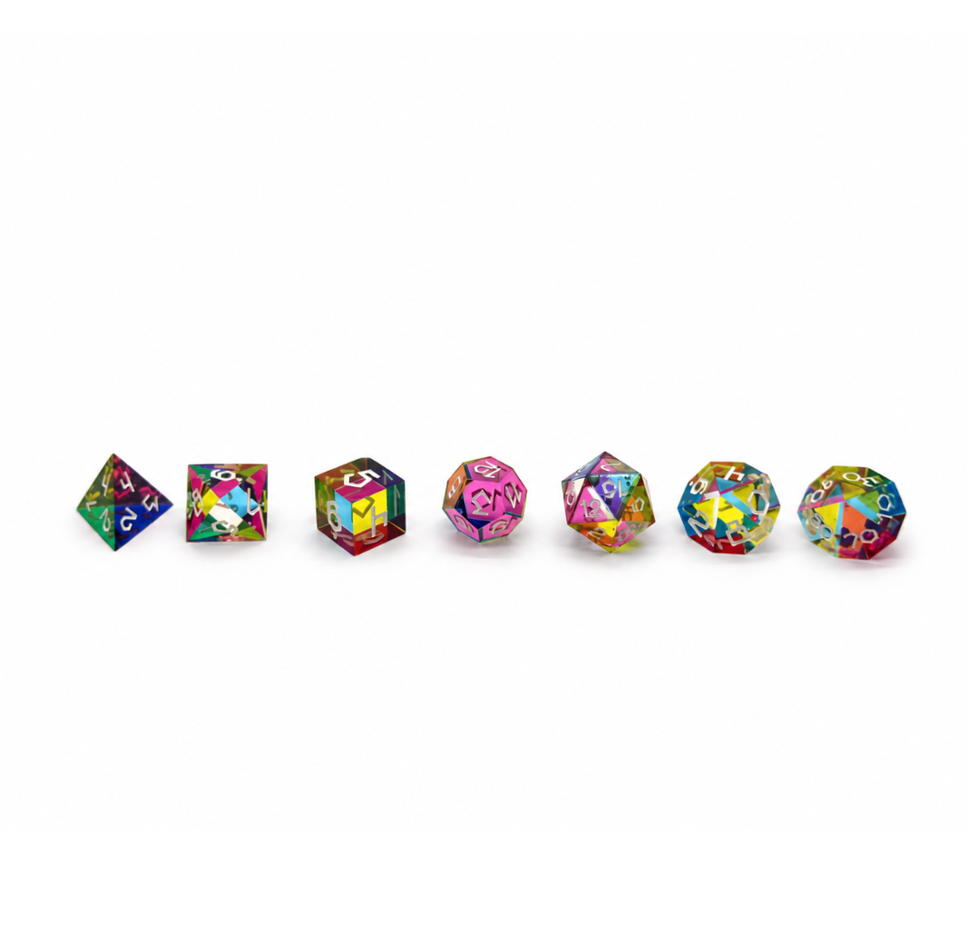 The seven CMY colour mixing dice from the Septem Aleae set lined up in a row
