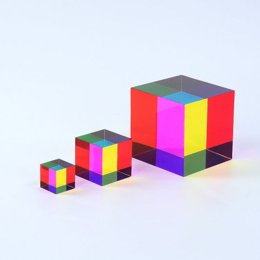 A translucent CMY Cube reflecting and transmitting light on a bright surface