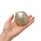 A pearl PolySquish Discovery Series #2 shape resting in the palm of a hand